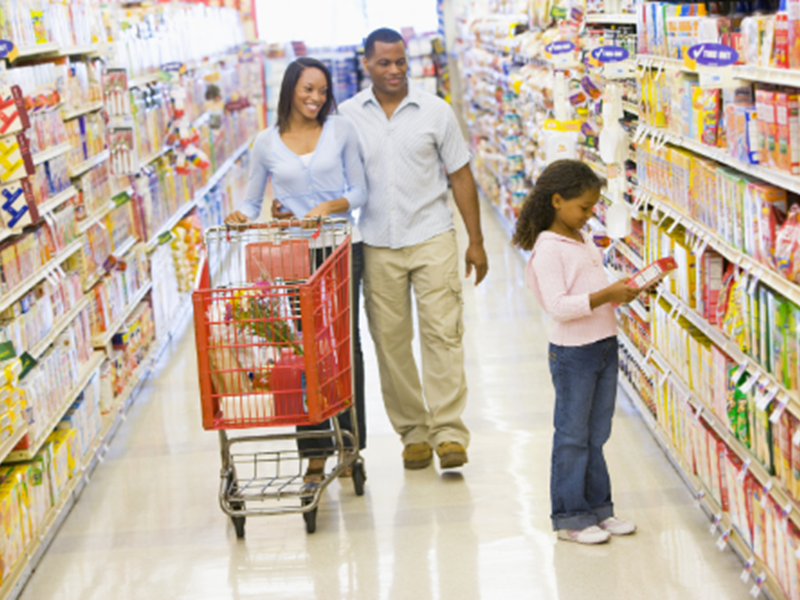 smiling family grocery shopping