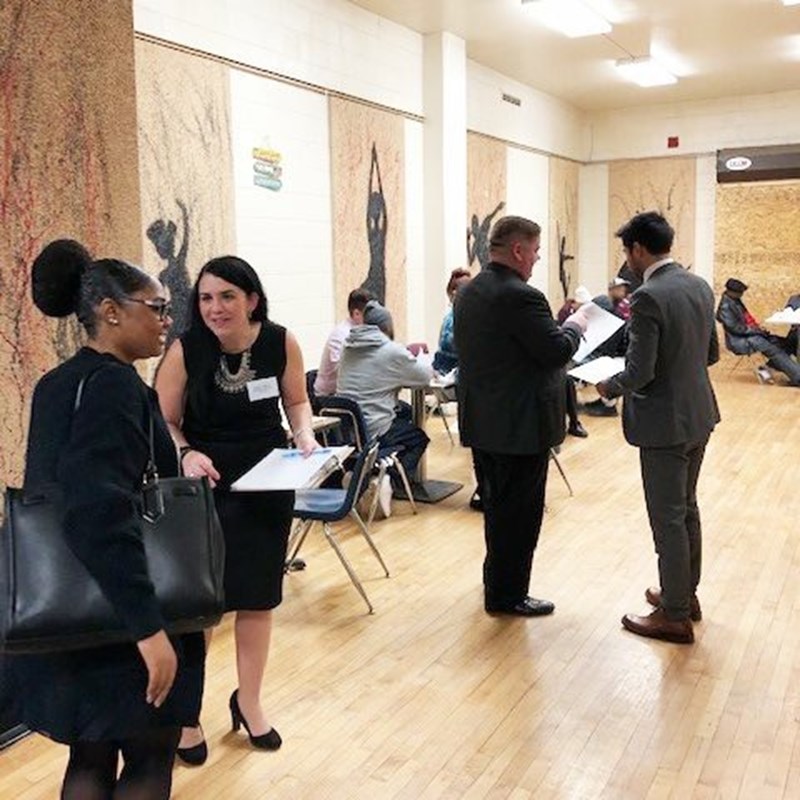 attorneys and clients talking at driver's license clinic