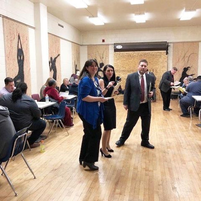 attorneys and clients talking at driver's license clinic