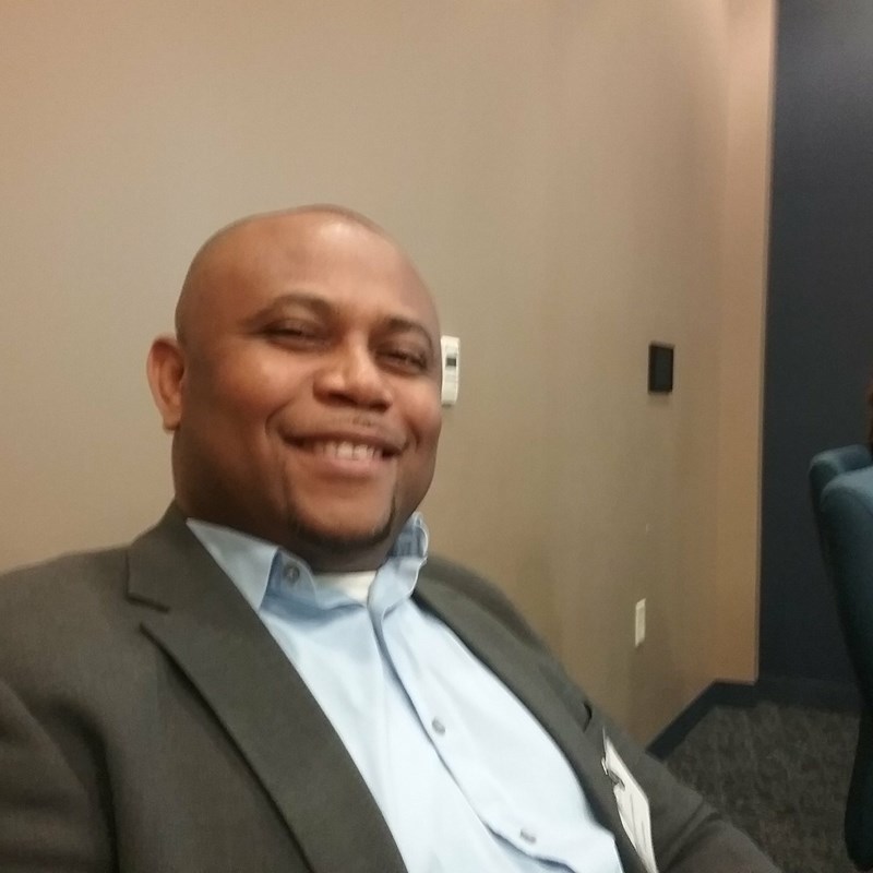 Fellow, smiling in office
