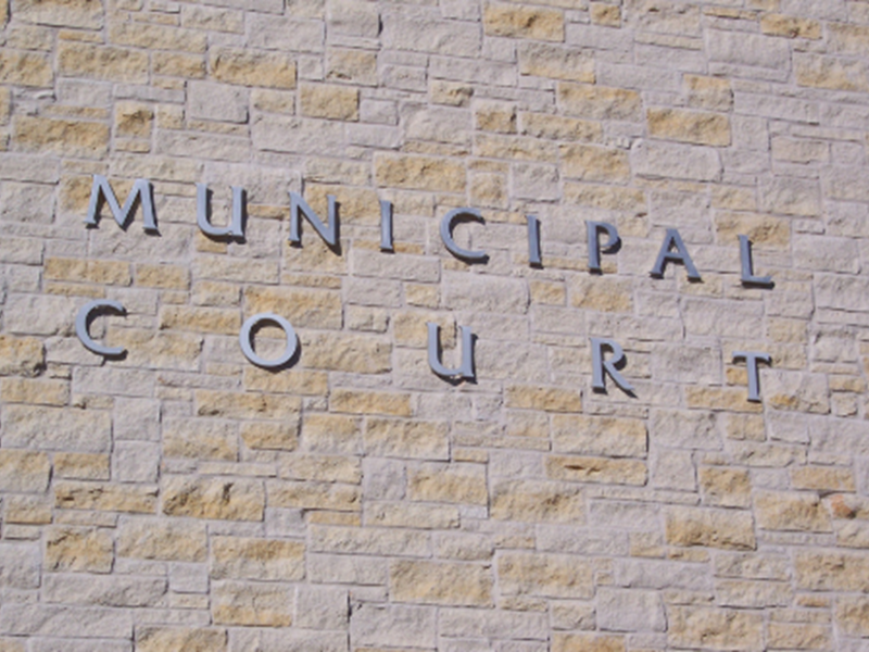 brick wall with "MUNICIPAL COURT" sign